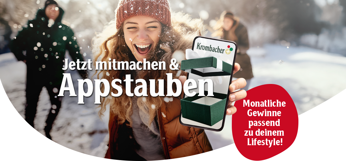 Frau hält Smartphone mit geöffneter Krombacher-App, im Hintergrund mehrere Personen im Freien im Schnee.
