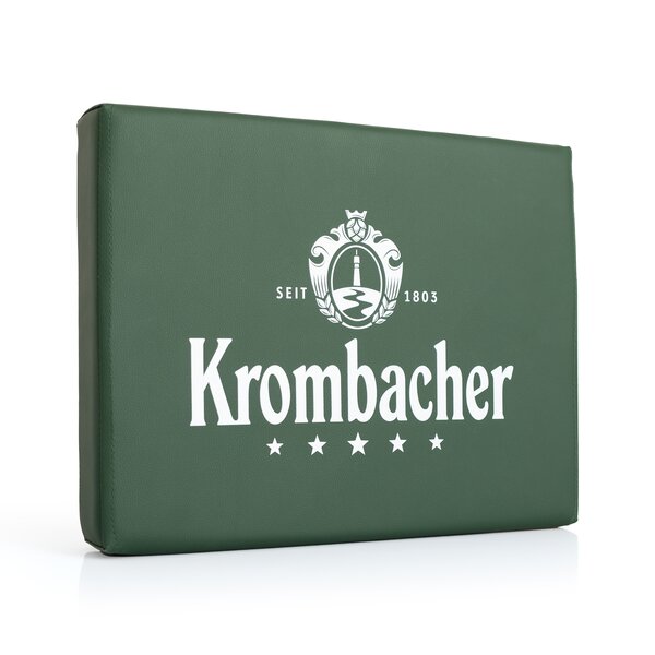 Grüne rechteckige Bierkistenauflage mit weißem Krombacher-Logo, Text 'Seit 1803' und fünf Sternen darunter.