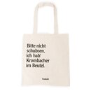 Beiger Jutebeutel mit schwarzem Text 'Bitte nicht schubsen, ich hab' Krombacher im Beutel' und kleinem Krombacher-Logo unten.
